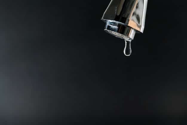 A close-up shot of a leaky faucet with water droplets falling, highlighting the importance of fixing leaks to conserve water. The background is slightly blurred to keep the focus on the dripping water and faucet.