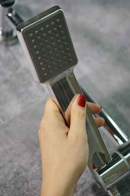 A person installing a low-flow showerhead in a bathroom, demonstrating the ease of installation. The bathroom is modern and well-lit, emphasizing the simplicity and benefit of the upgrade.