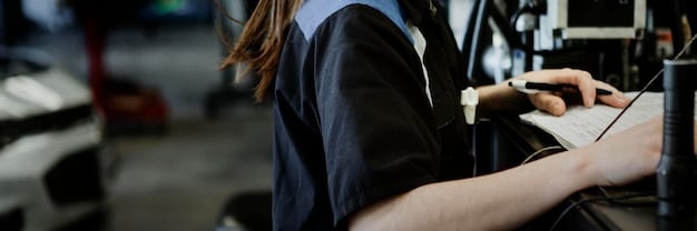 A mechanic performing a routine check-up on a hybrid car's engine in a well-lit garage. The focus is on the mechanic's hand checking the oil level with precision.