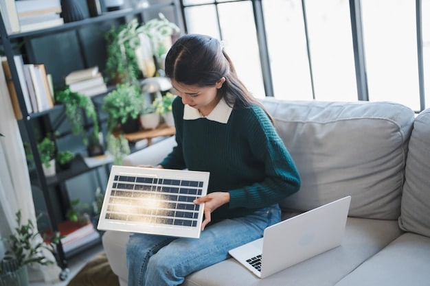 A person using an online energy savings calculator on a laptop, with a utility bill and a new appliance brochure nearby.