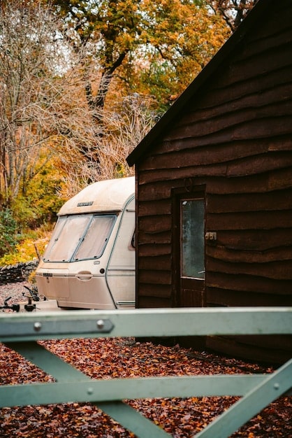 A cozy, eco-friendly cabin nestled in a forest, showcasing sustainable accommodation options with solar panels and a green roof. The image should inspire travelers to choose environmentally responsible lodging.