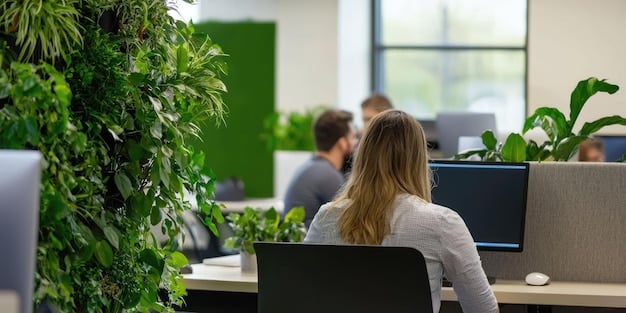 A bright and modern office space with employees working on computers surrounded by indoor plants, highlighting a socially responsible and environmentally conscious workplace.