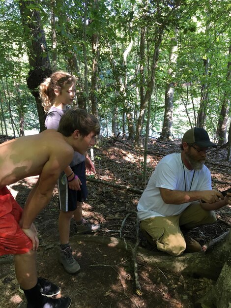 A group of conservationists and local community members planting native trees in a restored habitat, symbolizing collaborative conservation efforts to protect endangered species.