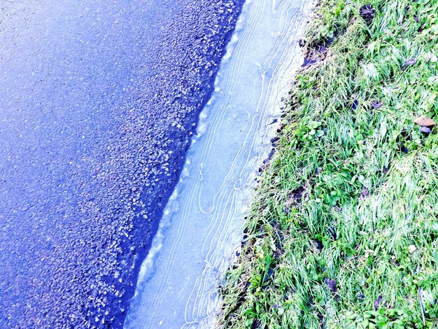 A split image showing a degraded stream bank before restoration and the same area after restoration with native vegetation and improved bank stability.