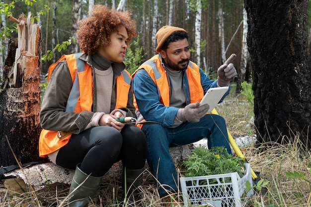A group of wildlife researchers working in a field, collecting data on a local animal population. The image should highlight the importance of scientific research in wildlife conservation efforts.