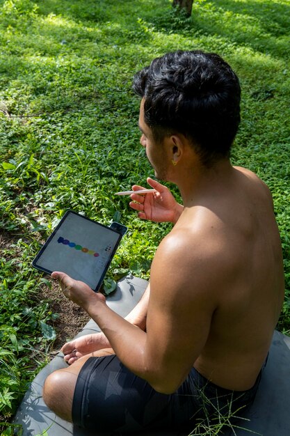 A close-up of a citizen scientist using a smartphone app in a forest to record data about a plant, with the app interface visible showing options to identify species and log observations.